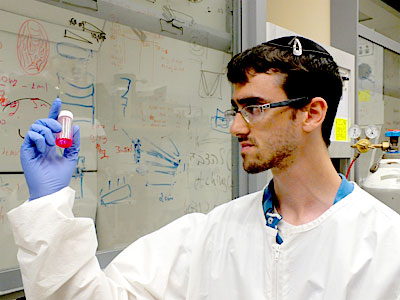 Matthew Feinstein a YU physics major from Philadelphia is working in Prof Yaakov Tischler’s lab to make a type of organic laser