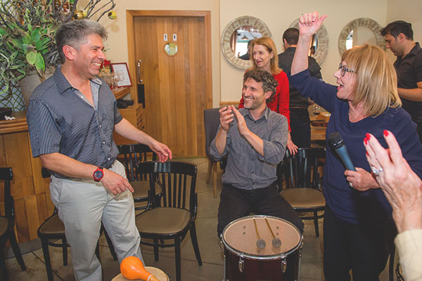 Dr. Avi Gilboa (left), together with Vera Muravitz, Chairman of the International Friends (right), drum up some excitement as Esther Tager (center back), wife of BFBIU Chairman Romi Tager, looks on
