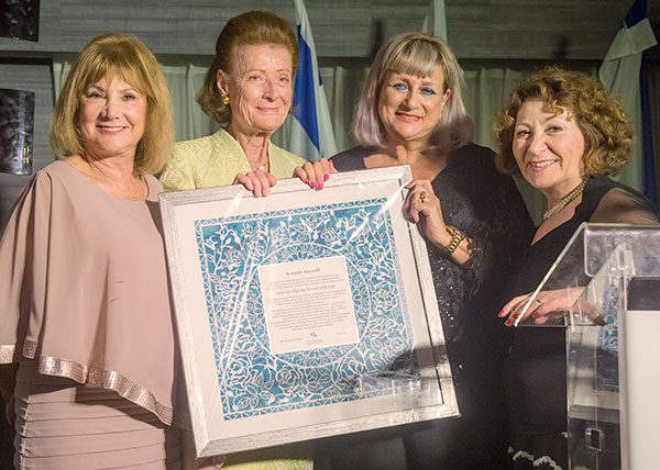 Retiring Vice President for External Relations Judith Haimoff (second from right) is presented with an artistic papercut attesting to her four decades of devoted service to Bar-Ilan University. Also pictured (l. to r.) Chairman of the International Friends Vera Muravitz, BOT Vice Chairman Jane Stern Lebell and AFBIU West Coast Director Karen Paul Reuven